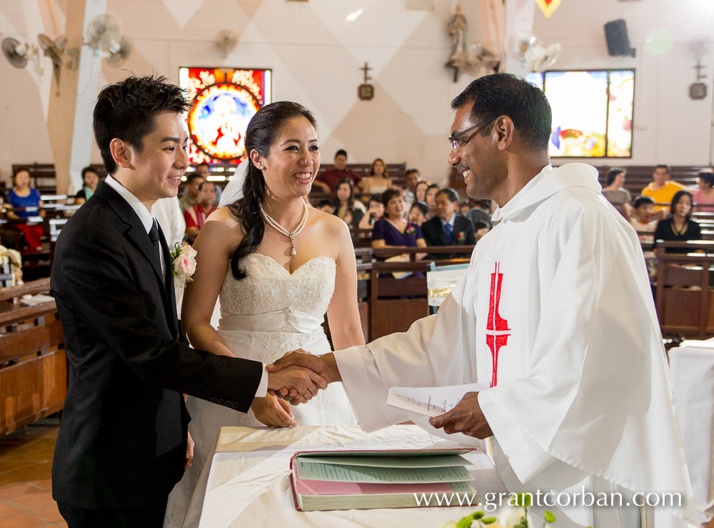 priest congratulates wedding couple Bride in car at wedding church of the holy spirit greenlane penang